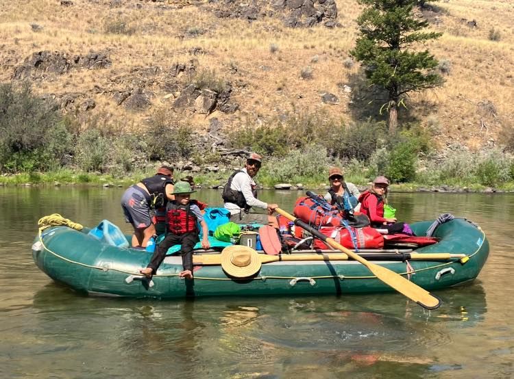 A group of people are riding a raft down a river.