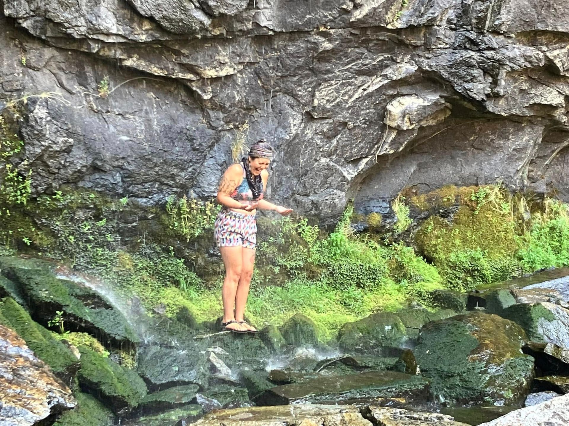 A woman is standing next to a river.