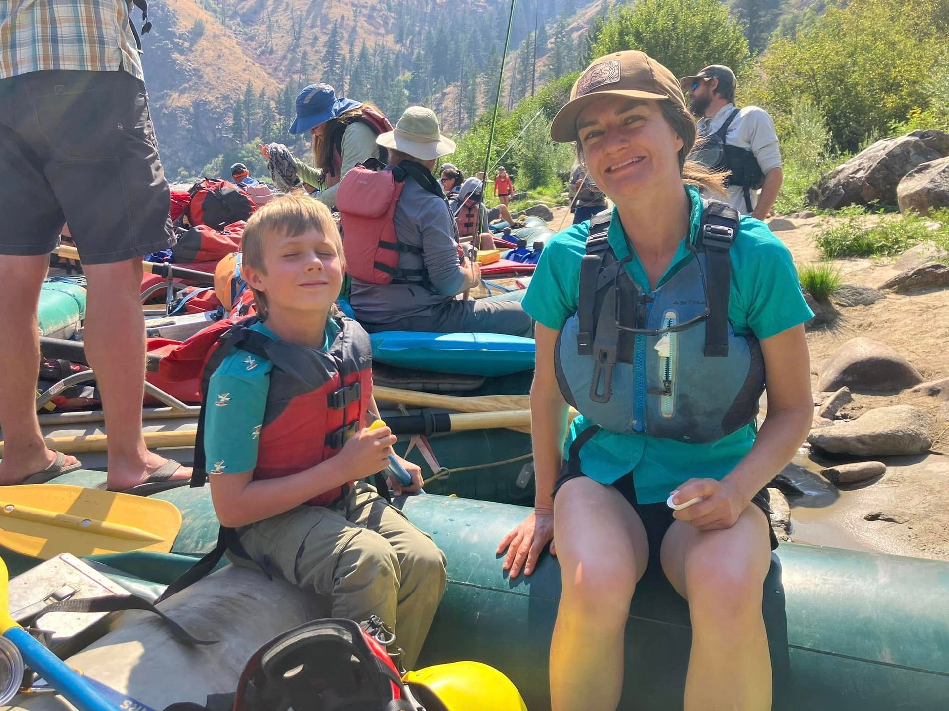 A woman and a boy are sitting on a raft.