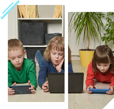 Three children are laying on the floor playing with their phones and laptops