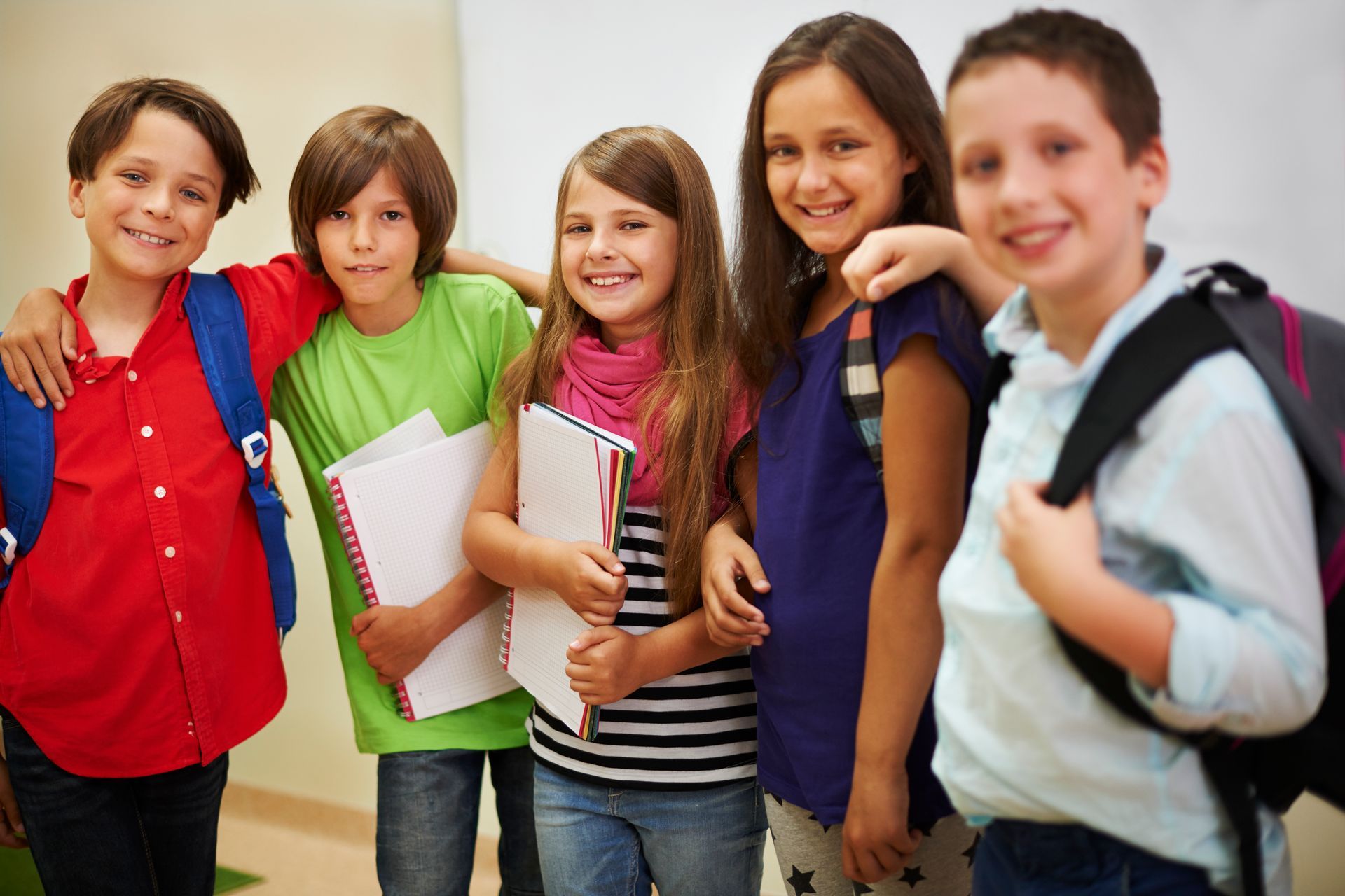 A group of children are posing for a picture in a classroom.