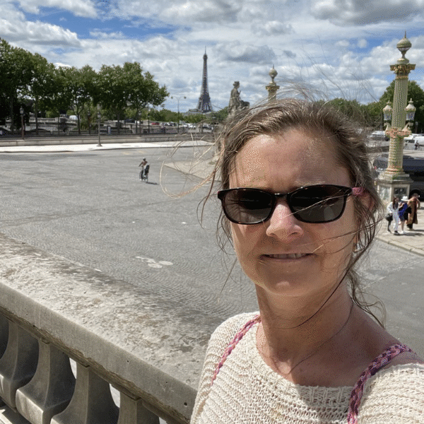 Photo of Cathie with the Eiffel Tower in the distance
