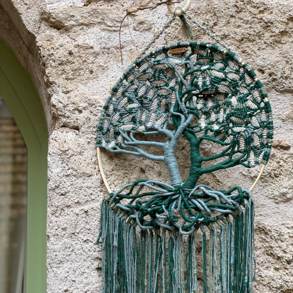 Tree of Life in multiple shades of green and cream with gold thread running through some of it. 