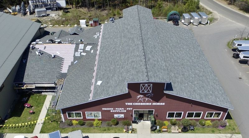 Aerial view of a gray-roofed, brown building, 