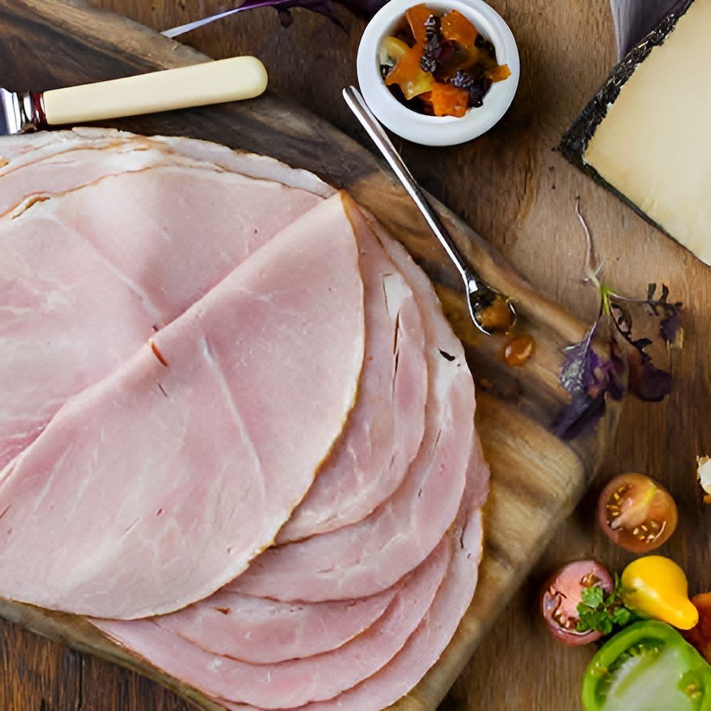 Slices of Ham on a Wooden Cutting Board — Corrado & Frank Distributors in Shellharbour, NSW