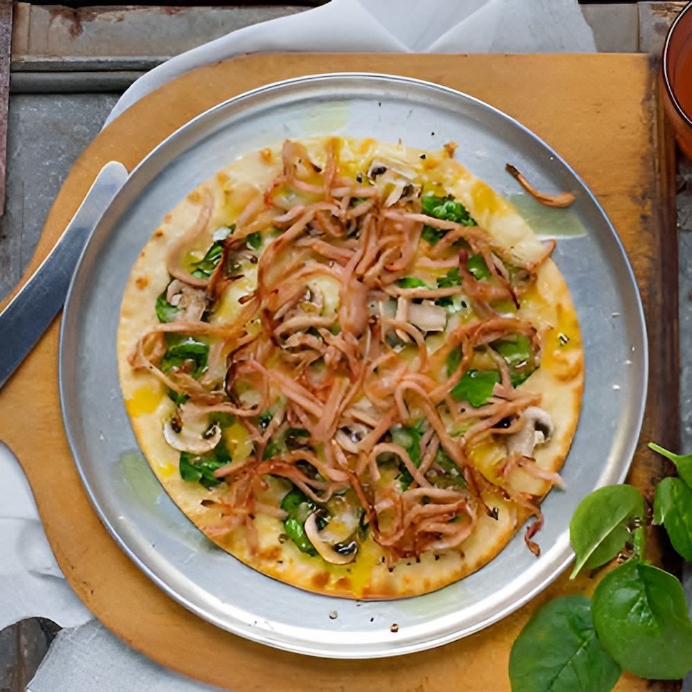 A Pizza With Spinach and Mushrooms on a Pan — Corrado & Frank Distributors in Fairy Meadow, NSW