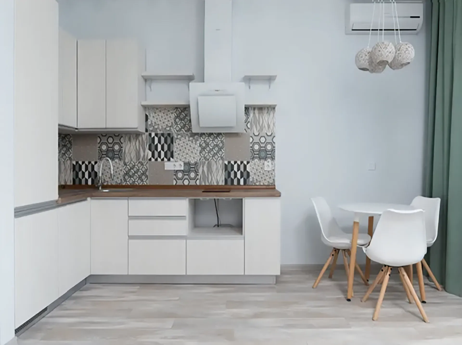 A modern kitchen in white tones with tile backsplash
