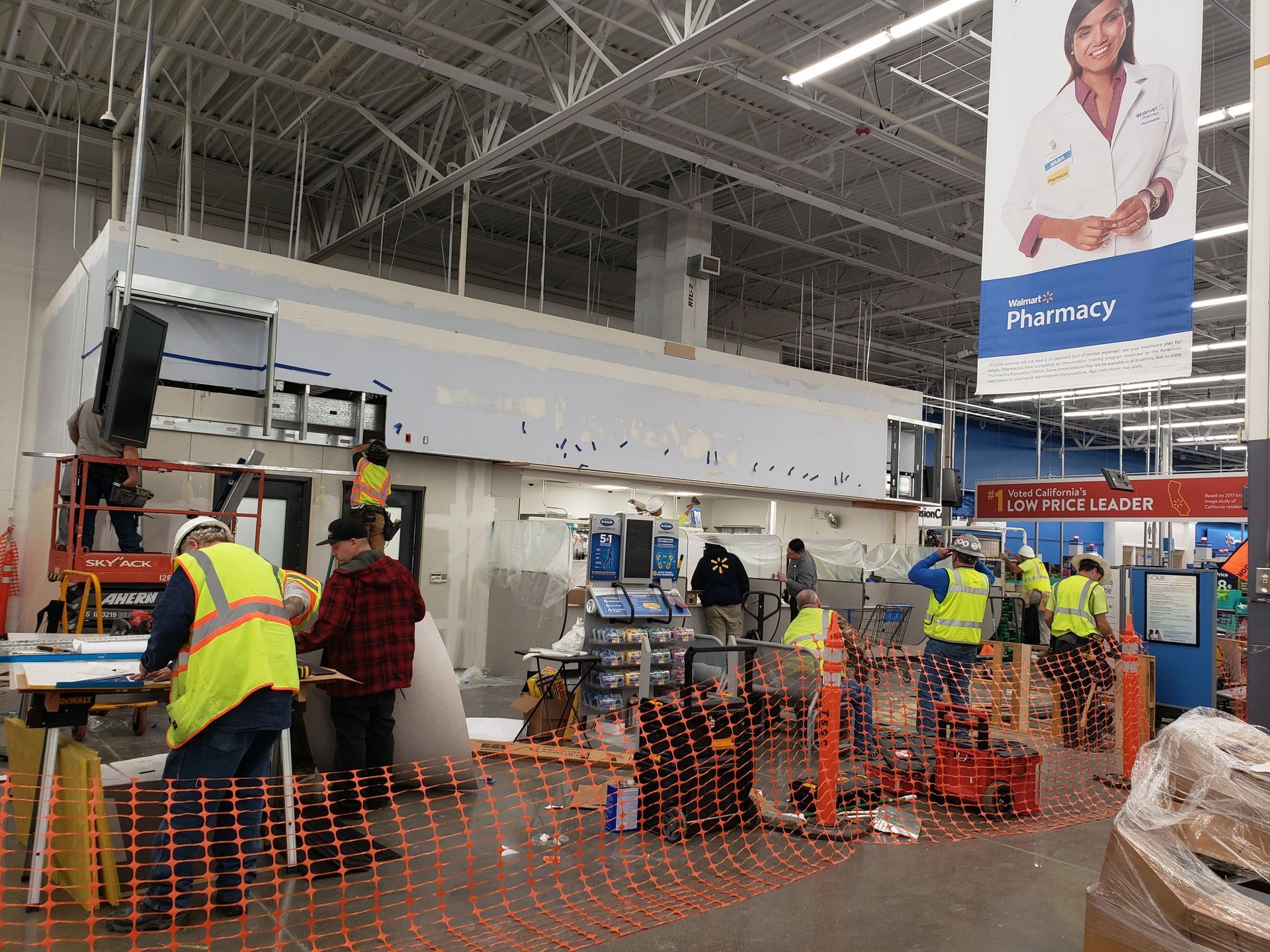 workers prep drywall in a Walmart pharmacy