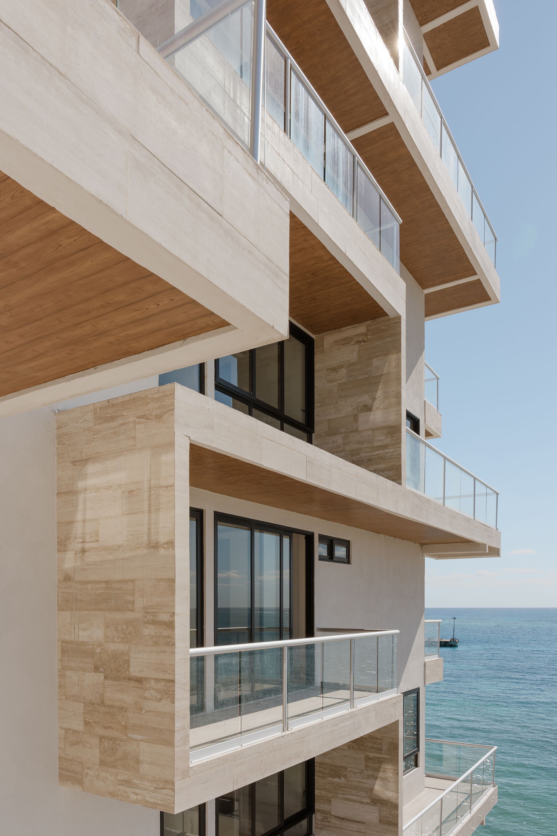 A building with a lot of windows and balconies overlooking the ocean