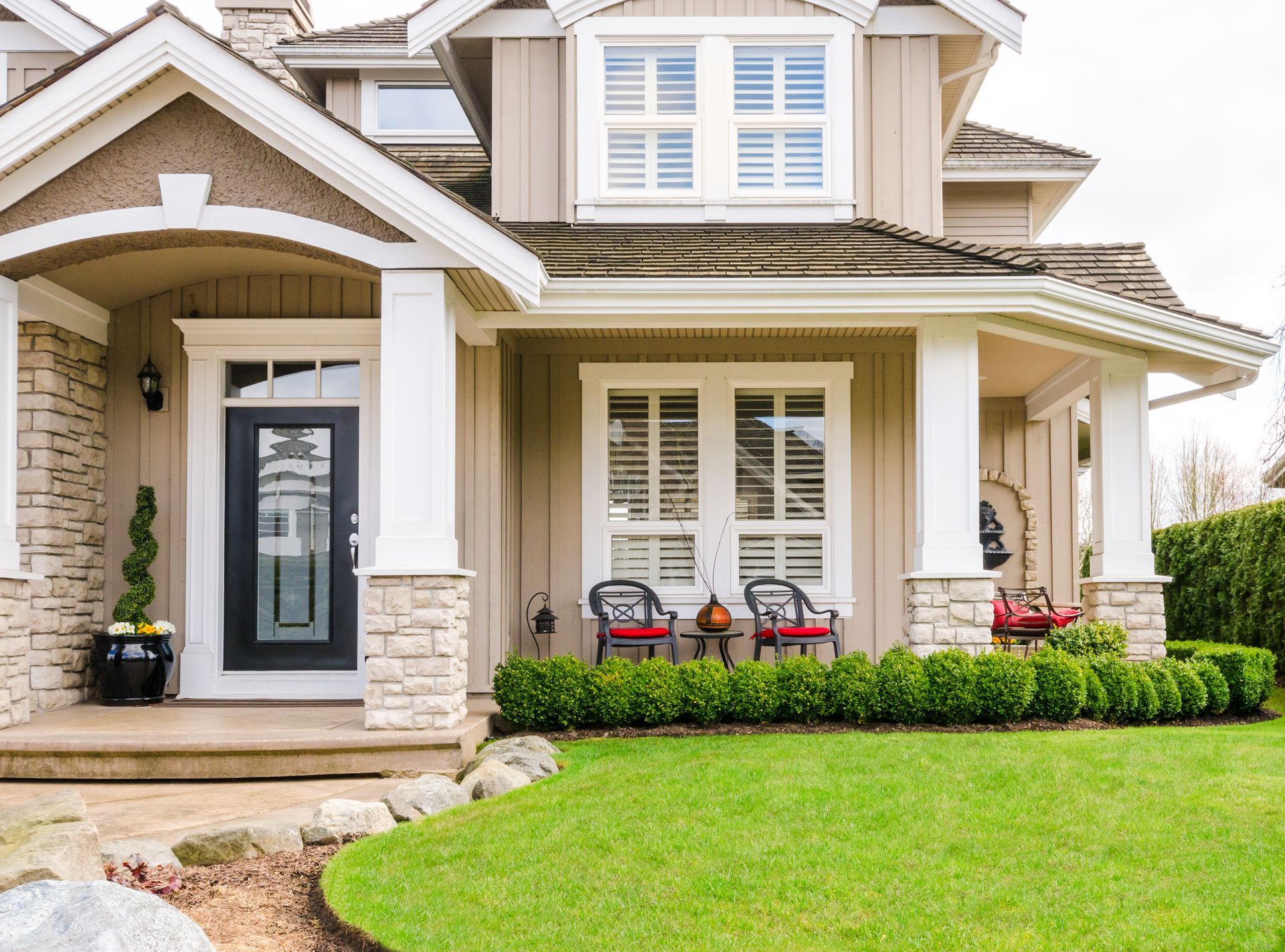 A large house with a large lawn in front of it.