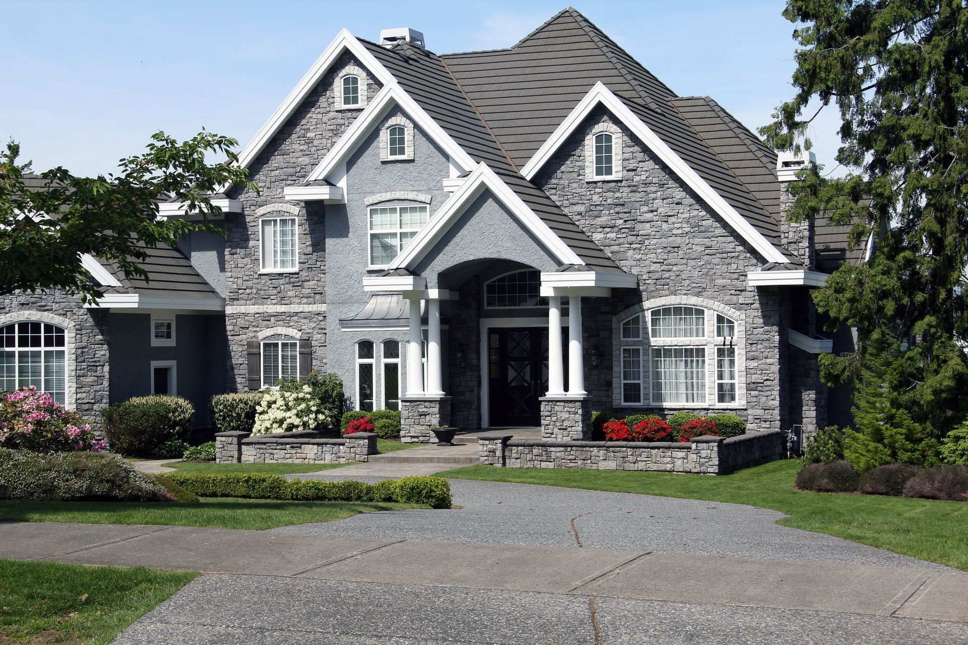 A large house with a driveway in front of it