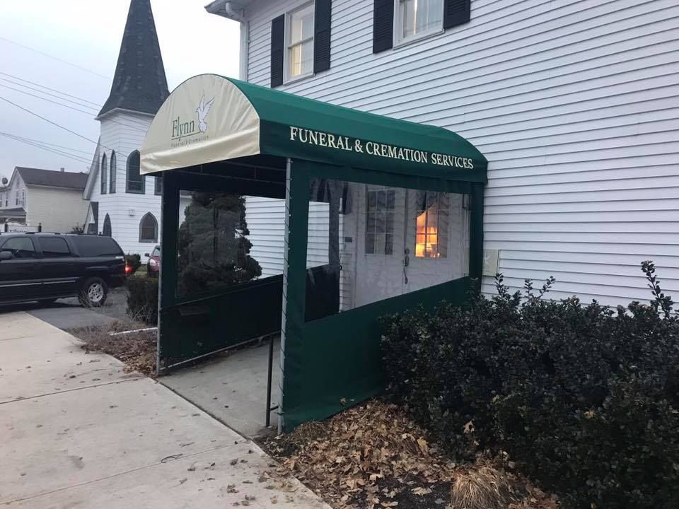 A woman is holding a lit candle in her hands.