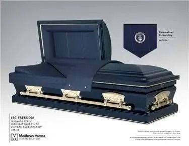 Dark blue casket with open lid, gold hardware, and navy interior.