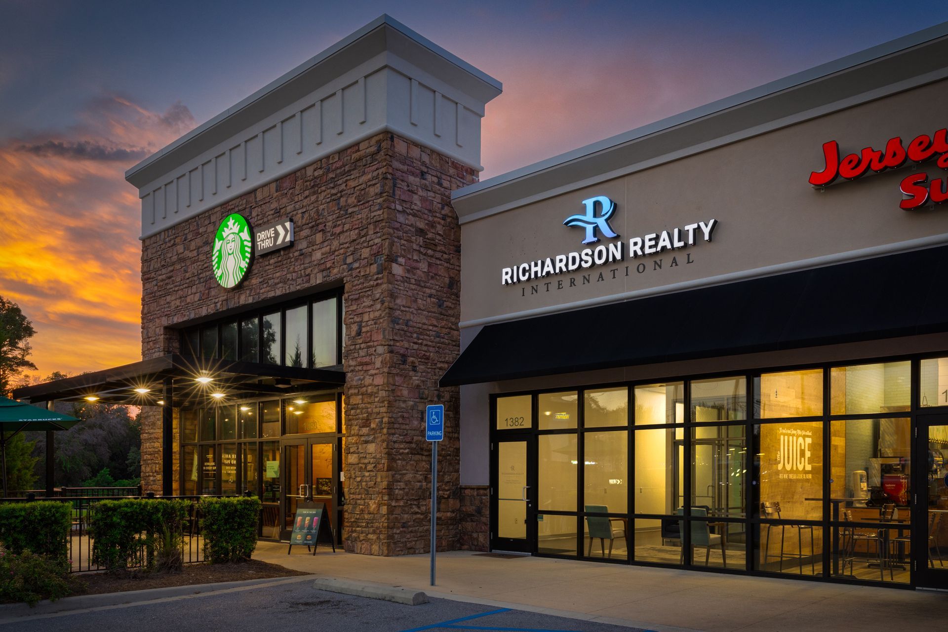 Starbucks and Richardson Realty storefronts at sunset.