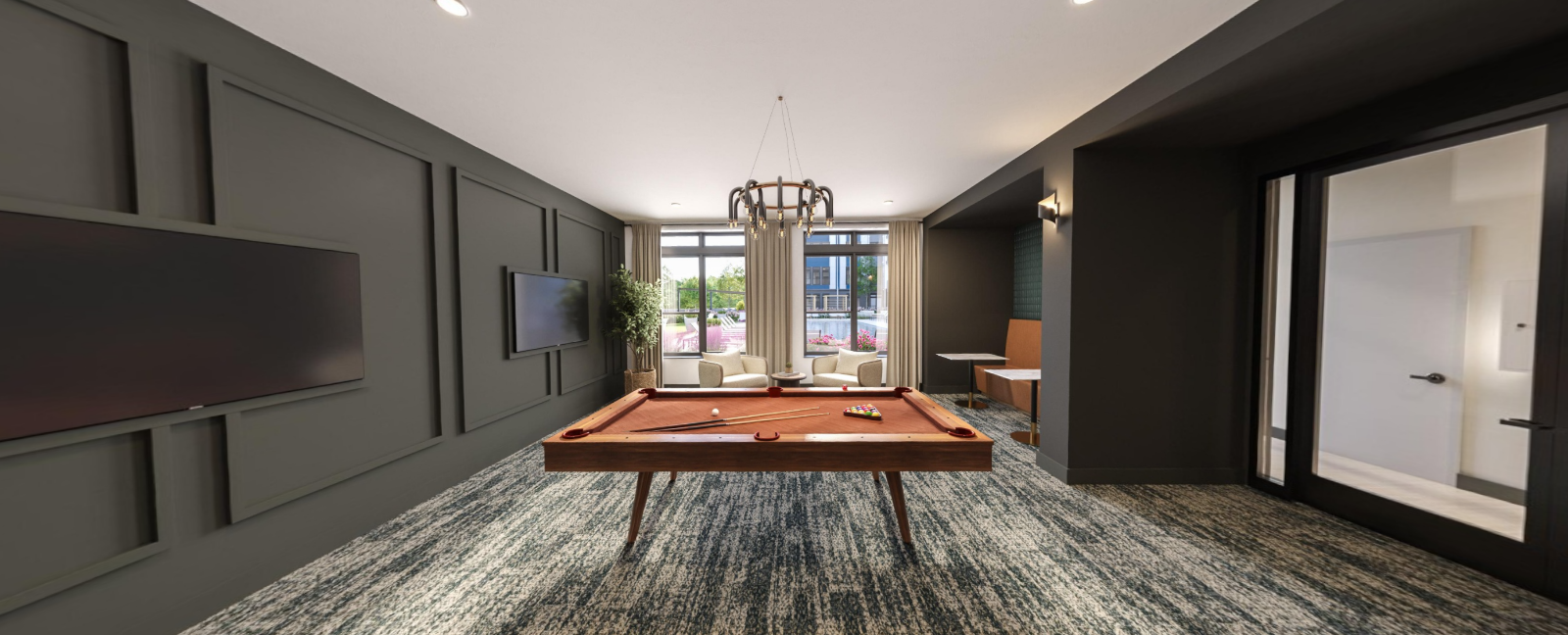 Modern living room with dark walls, large TV, patterned rug, and glass doors opening to a patio at Vela Park apartments in East Lake, Atlanta, GA.