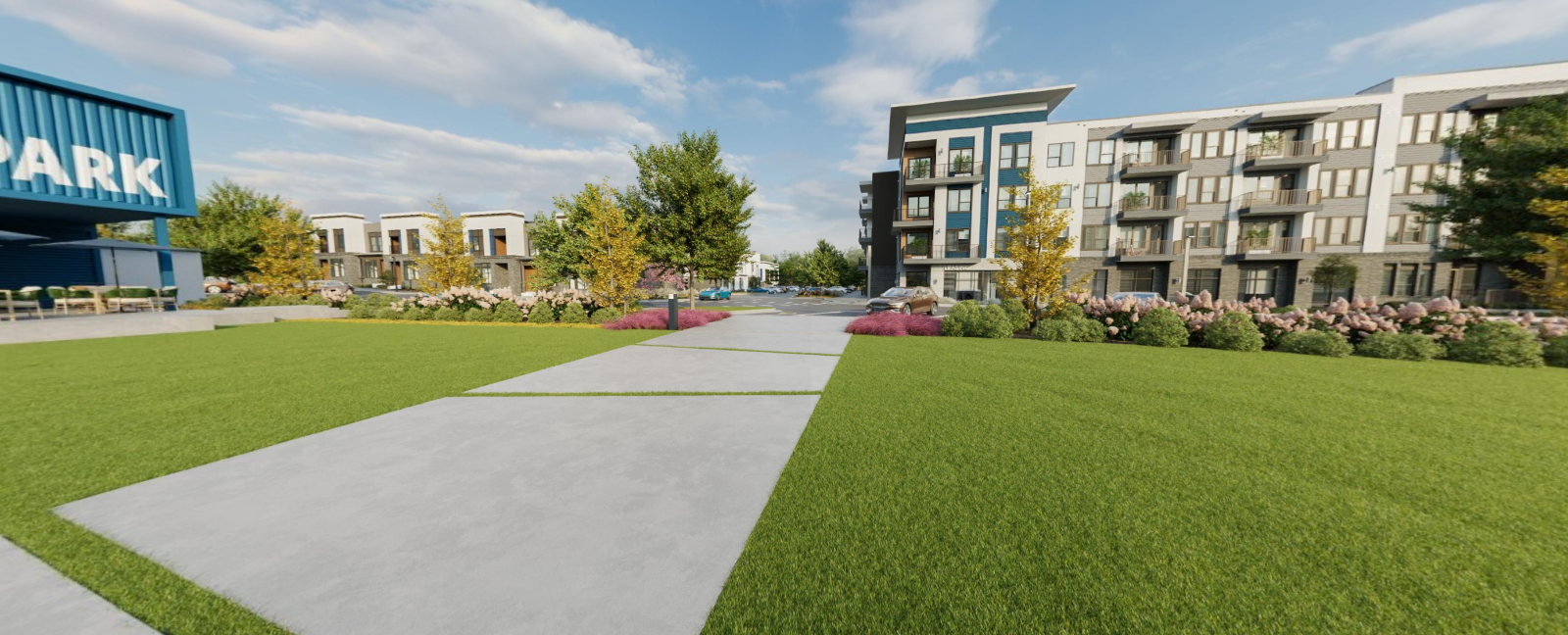 Modern apartment complex with green lawn and a paved walkway under a blue sky at Vela Park apartments in East Lake, Atlanta, GA.