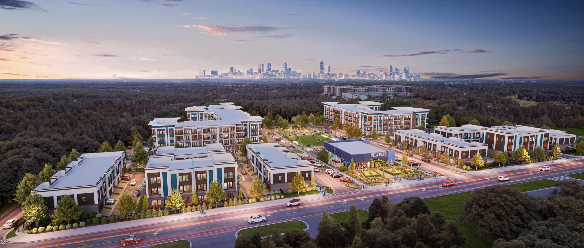 Aerial view of a modern apartment complex at dusk with city skyline in the distance at Vela Park apartments in East Lake, Atlanta, GA.