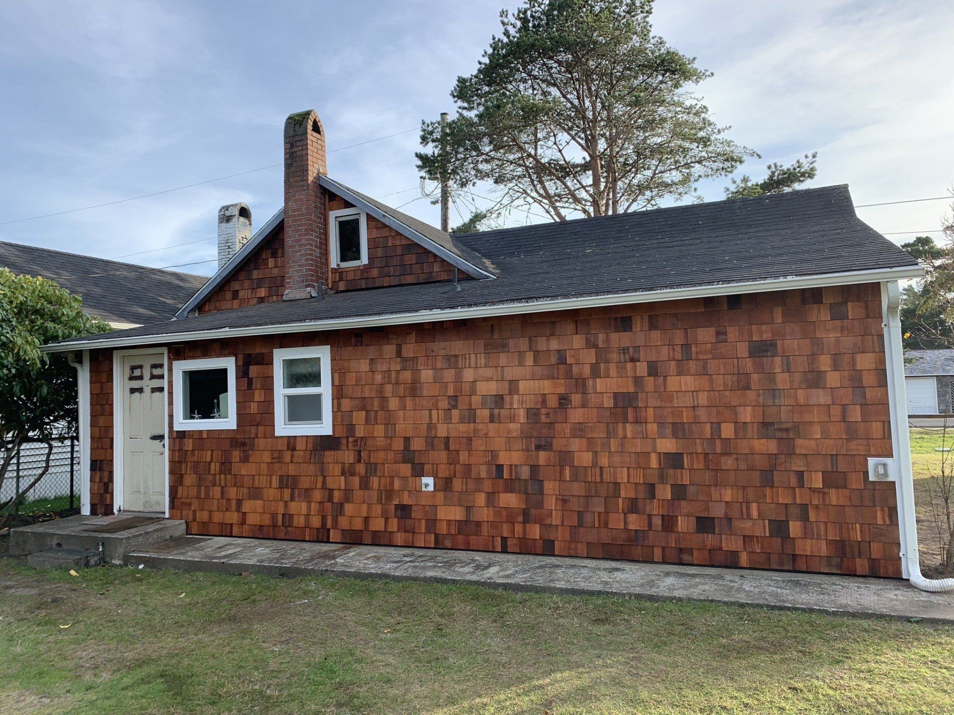 Emergency roofer in Long Beach, WA fixing a damaged roof after a storm