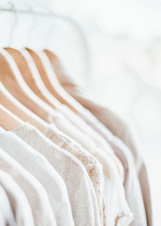 white clothes on a row of hangers