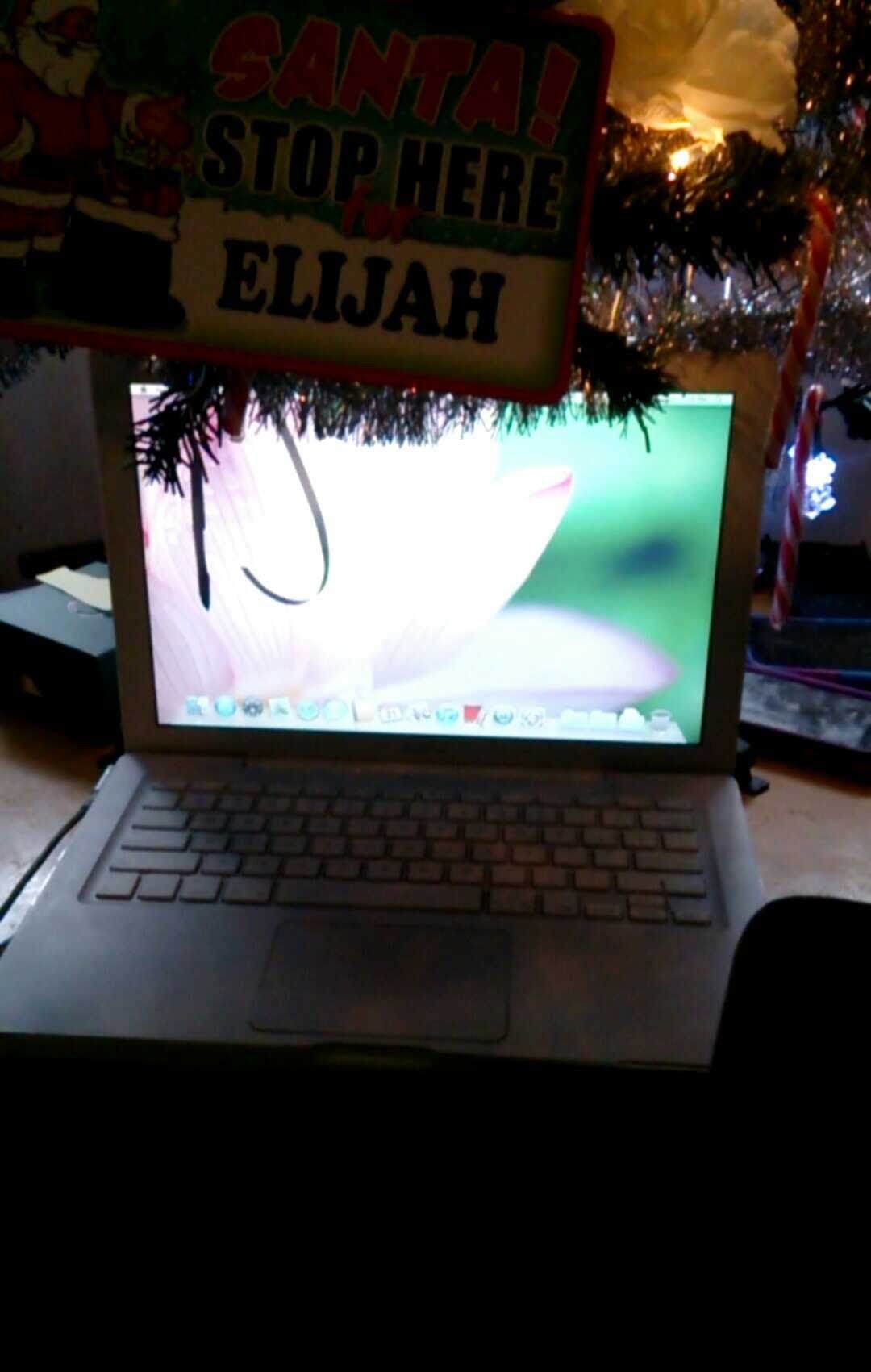 Laptop with a flower screensaver, decorated with Christmas garland and a 