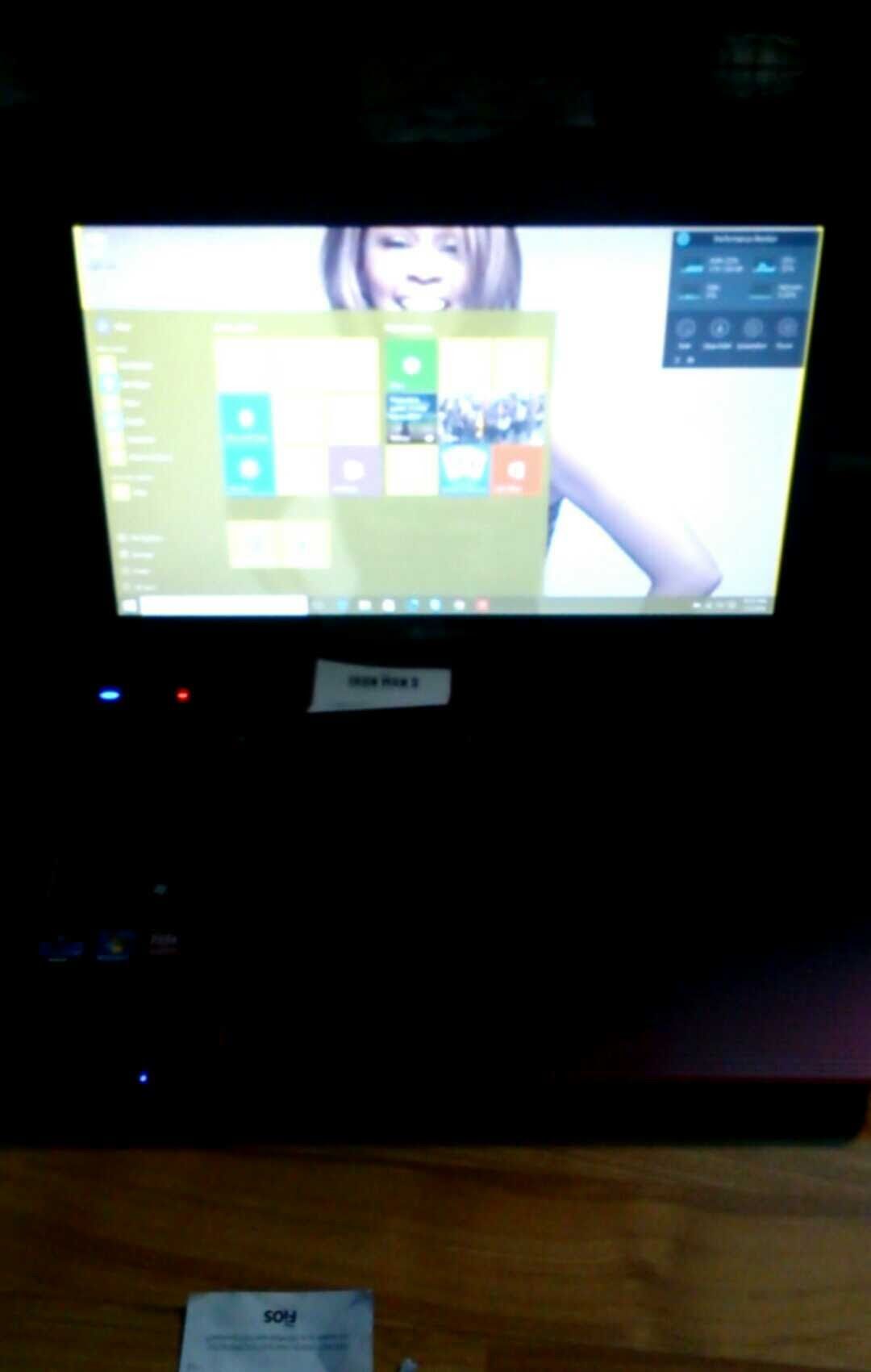 A computer monitor showing a Windows start menu with a stylized anime character background. The computer case is black.