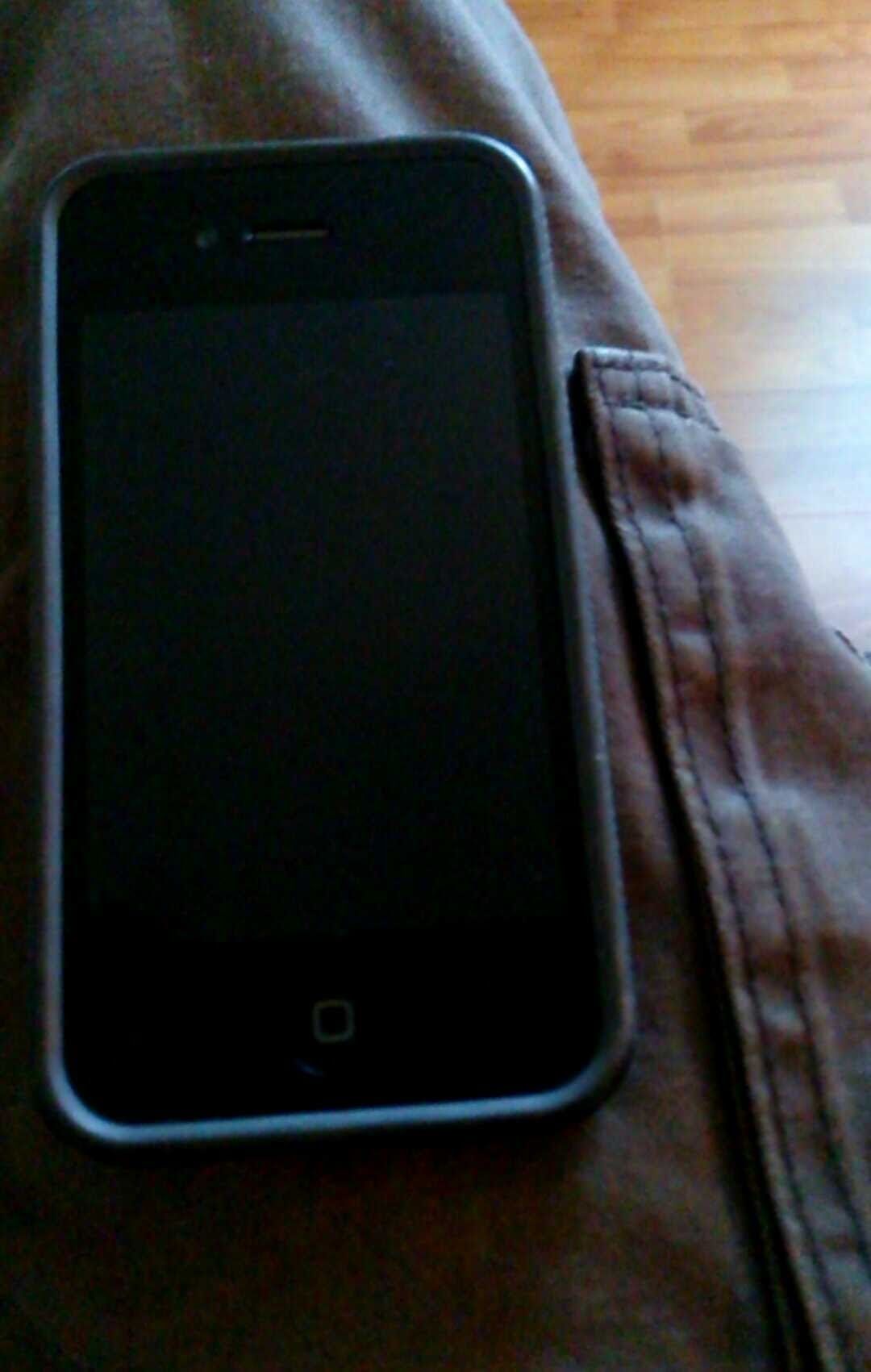 Black iPhone on brown pants.