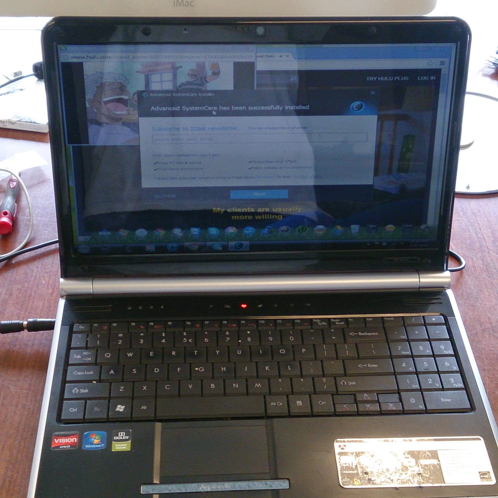Open laptop displaying a website with a dialog box, on a wooden surface.