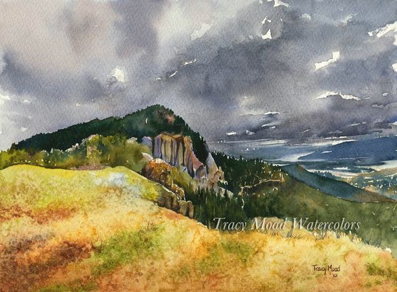 Watercolor painting of a mountain under a dramatic, stormy sky.  Green foliage covers the mountain, with exposed rock cliffs. Yellow-brown grass in the foreground.