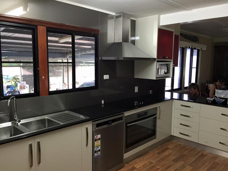 A Kitchen With Stainless Steel Appliances And White Cabinets — Keilbach Kitchens In Garradunga, QLD