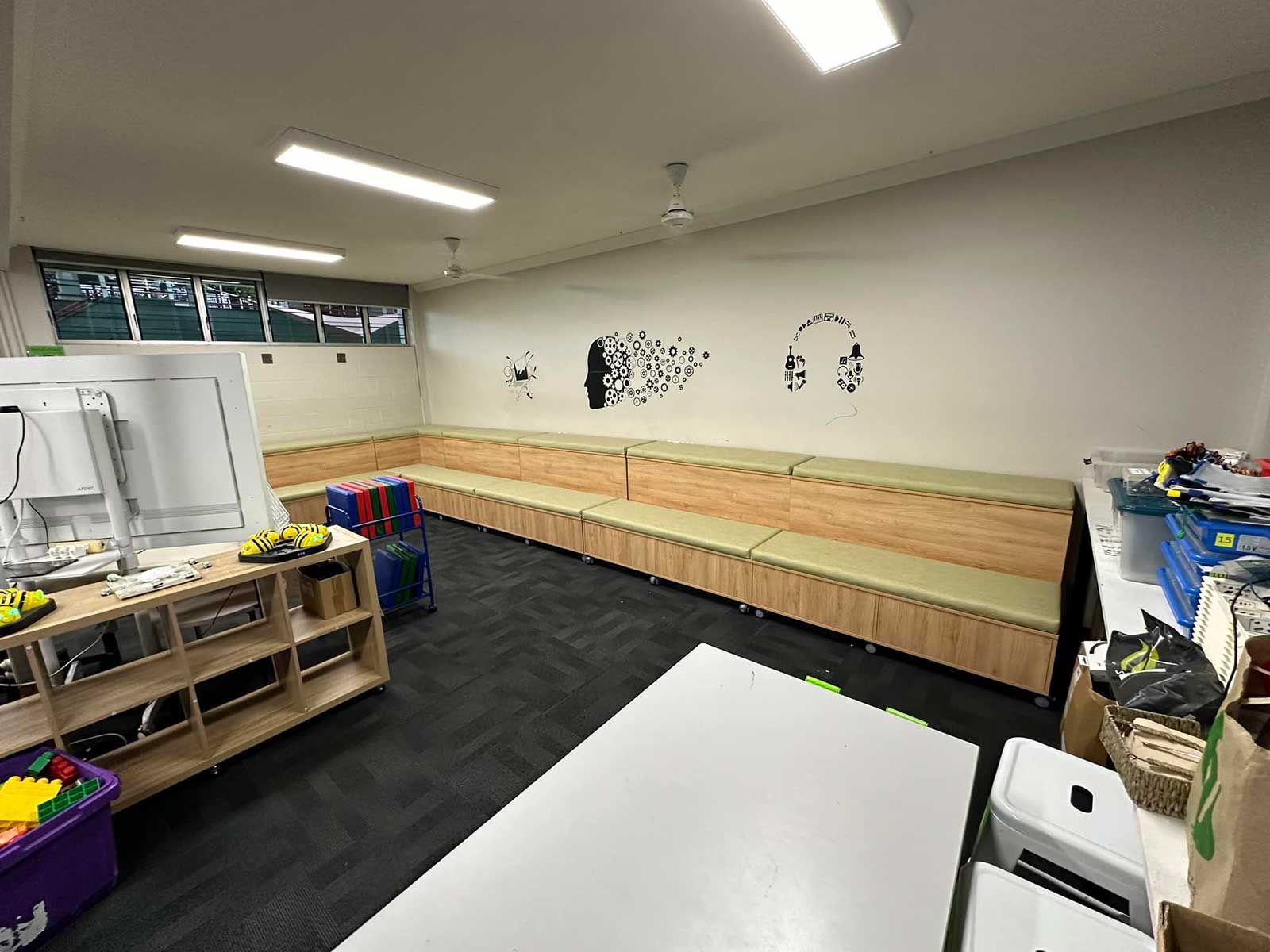 A Classroom With A Long Row Of Benches And A Table — Keilbach Kitchens In Cairns, QLD