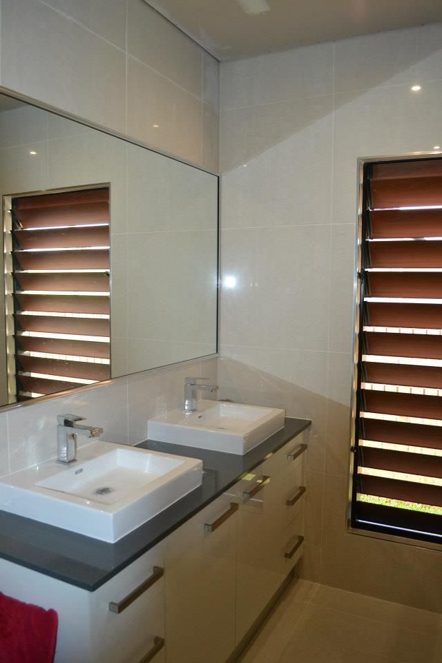 A Bathroom With Two Sinks And A Large Mirror — Keilbach Kitchens In Garradunga, QLD