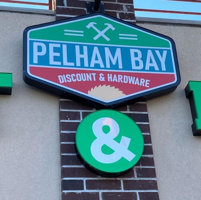Pelham bay discount and hardware sign on a brick wall
