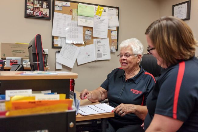 Two of Controlled Aire's HVAC Employees Going Over Heating & AC in Their Moberly, MO Office.