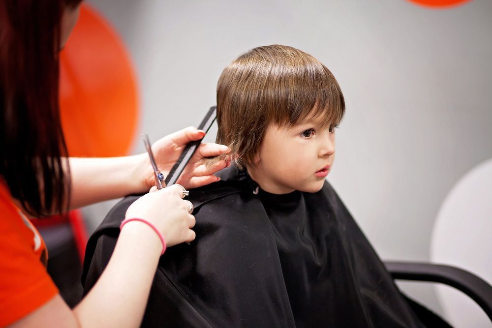 A Little Boy Is Getting His Hair Cut At A Hair Salon — Arabella Hair Design in Sebastopol, VIC
