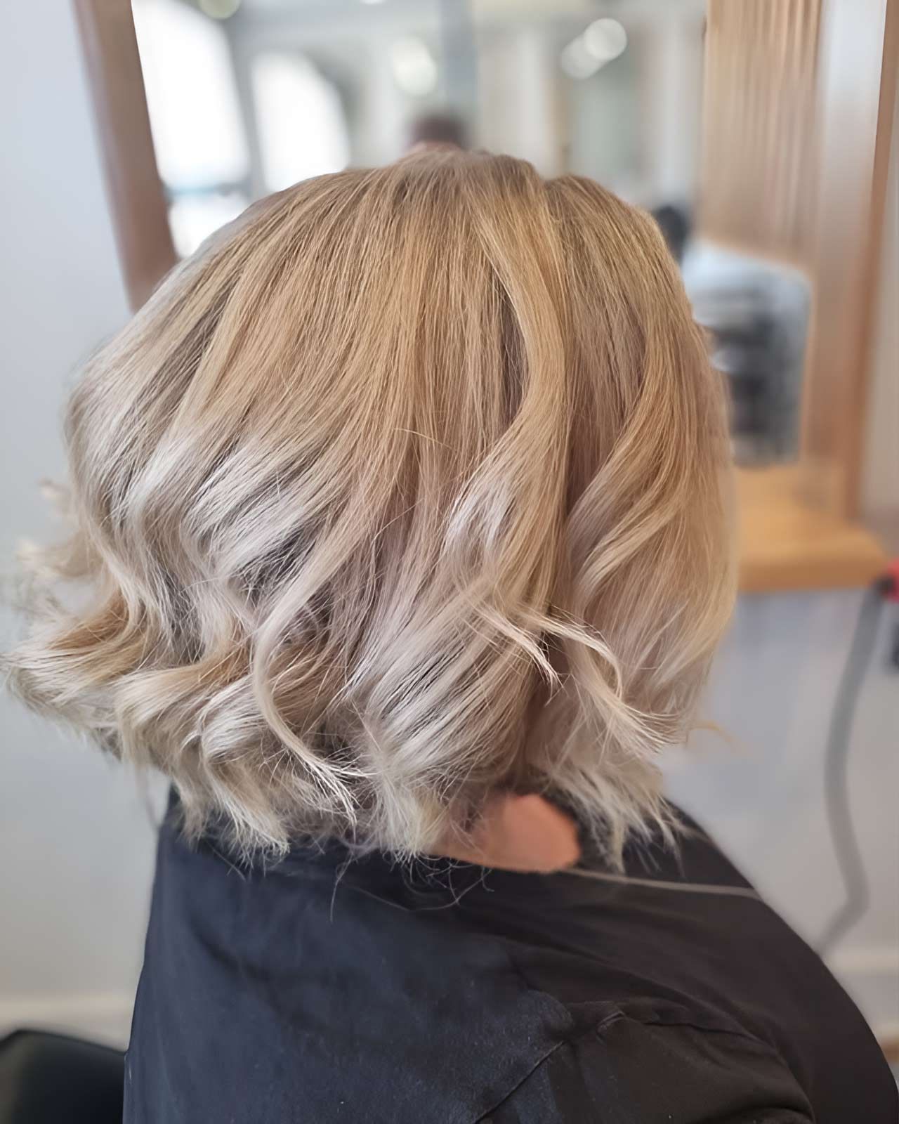 A Woman With Blonde Hair Is Sitting In A Chair In The Hair Salon — Arabella Hair Design in Sebastopol, VIC
