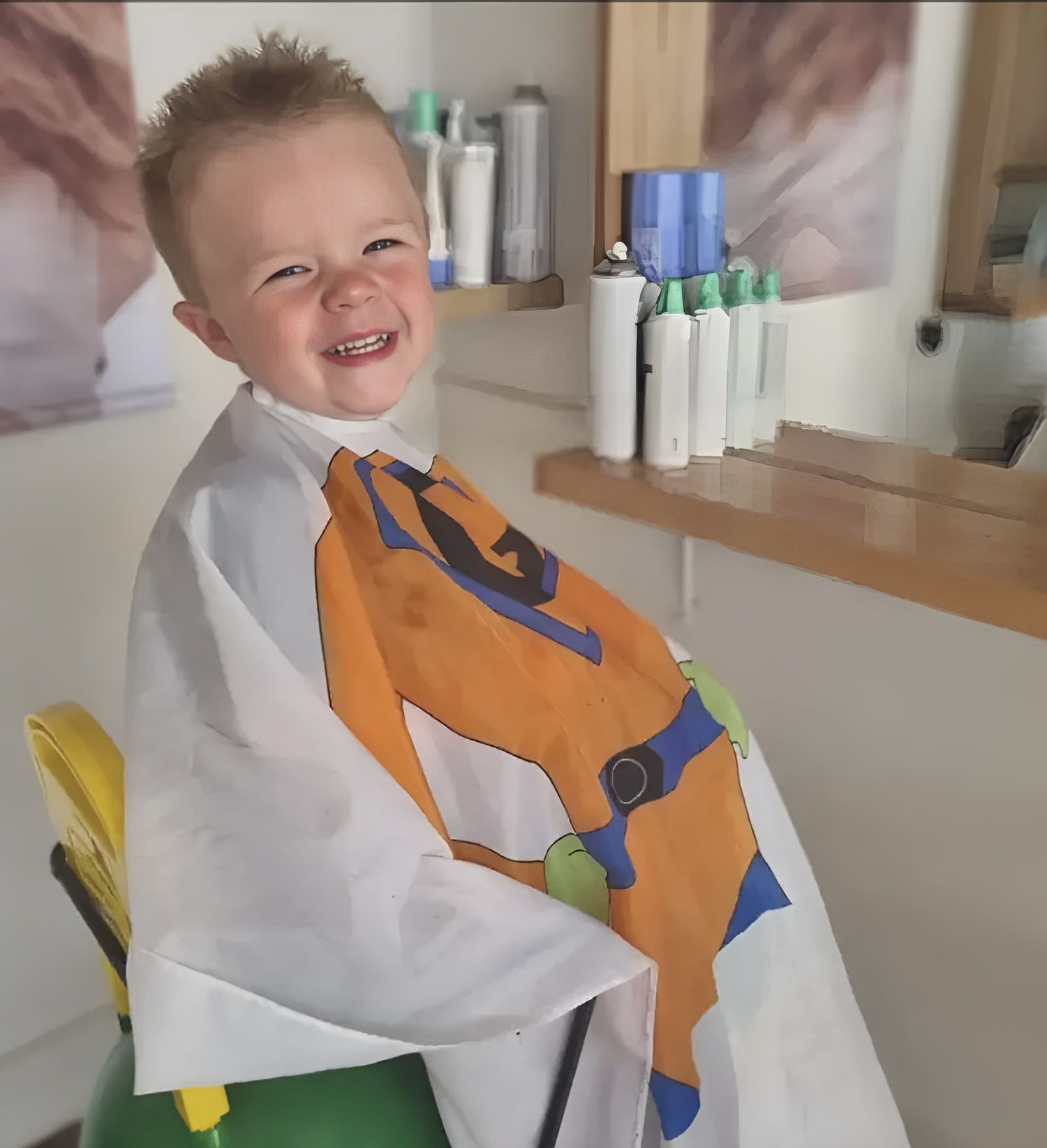 A Little Boy Wearing A Cape With A Horse On It Getting Haircut — Arabella Hair Design in Sebastopol, VIC