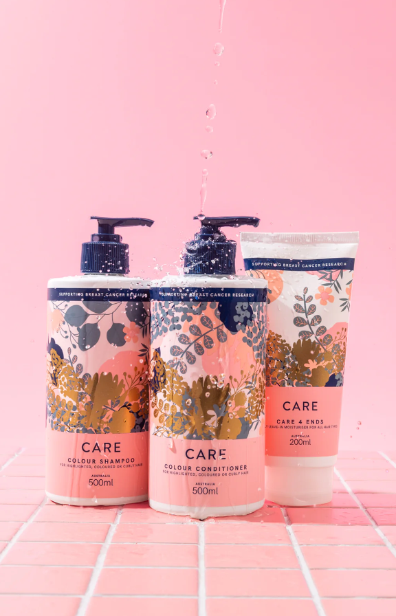 Three Bottles of Lotion are Sitting on a Pink Tile Floor — Arabella Hair Design in Sebastopol, VIC