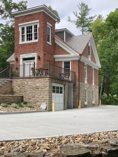 A person is spreading adhesive on a tile floor with a trowel.
