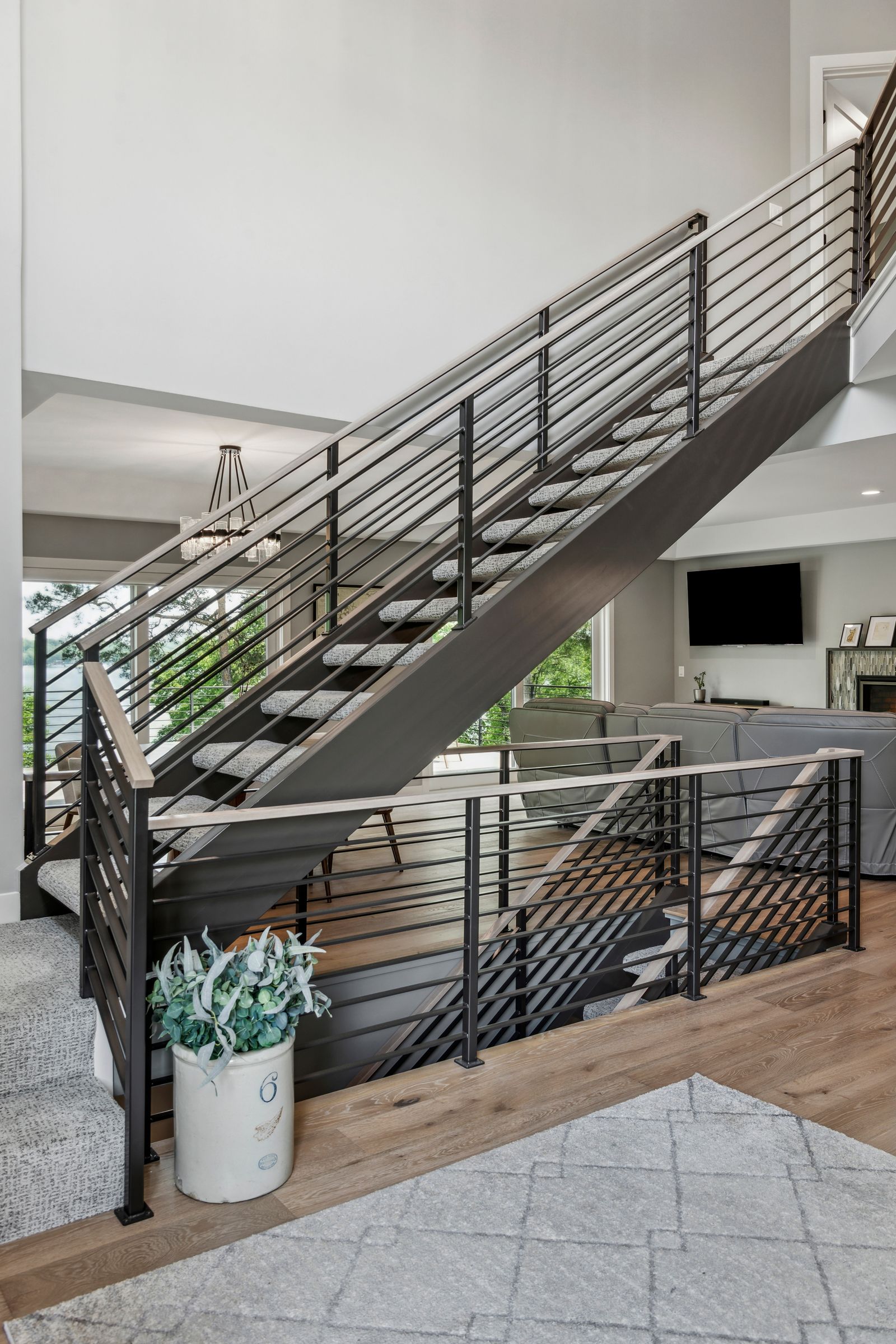 Modern staircase with black metal railings and wood accents.