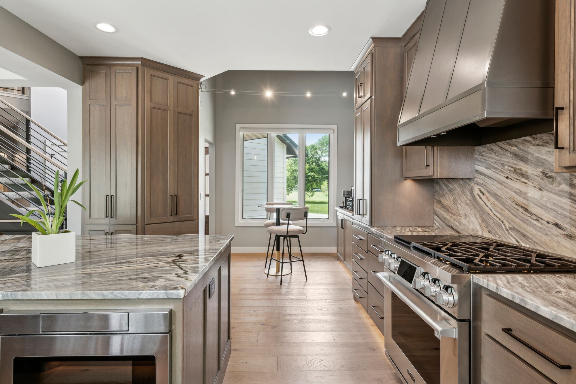 Modern kitchen with granite countertops, stainless steel appliances, and wooden cabinets.