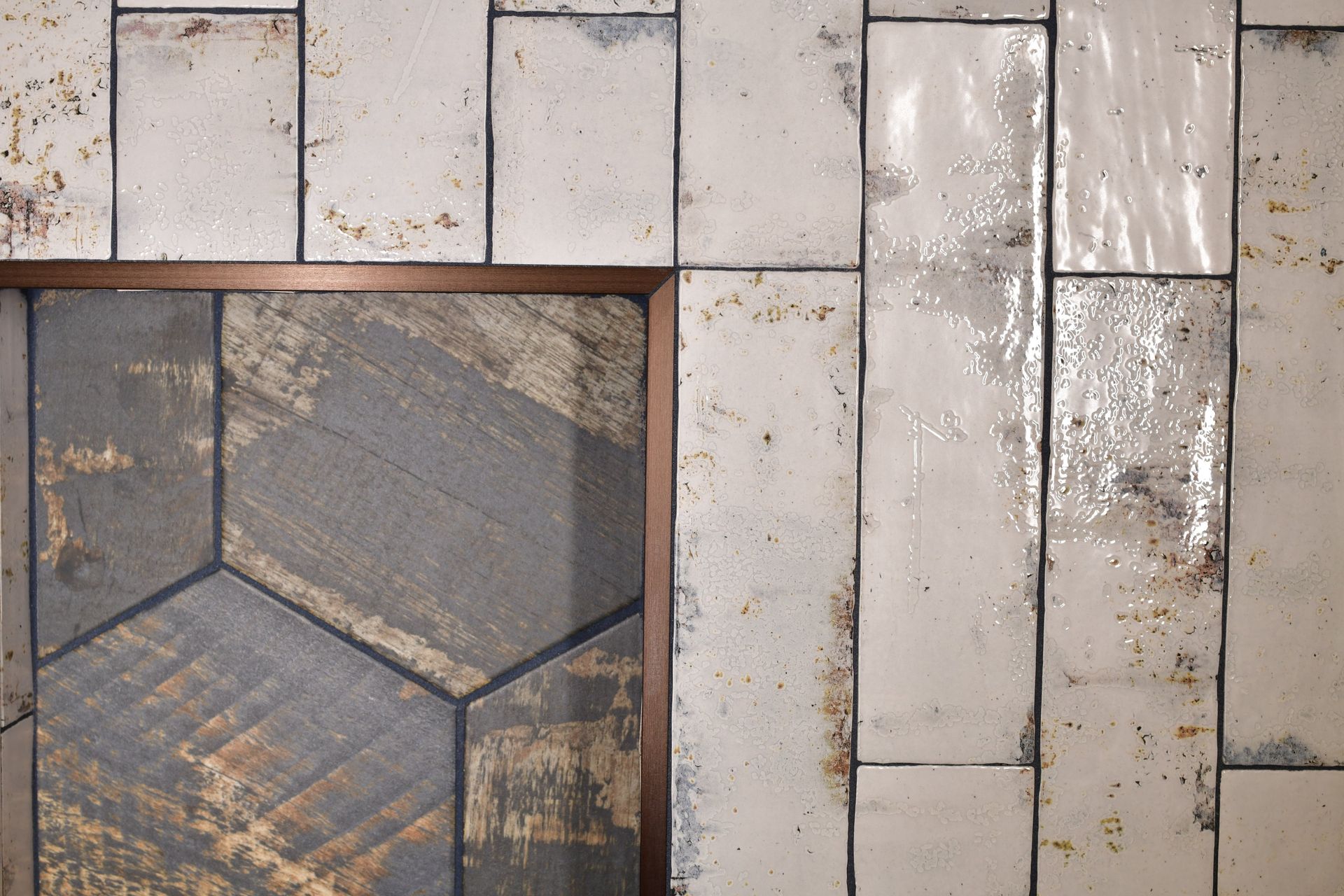 Wall with textured off-white tiles, and a hexagonal wood-look insert framed in brown.