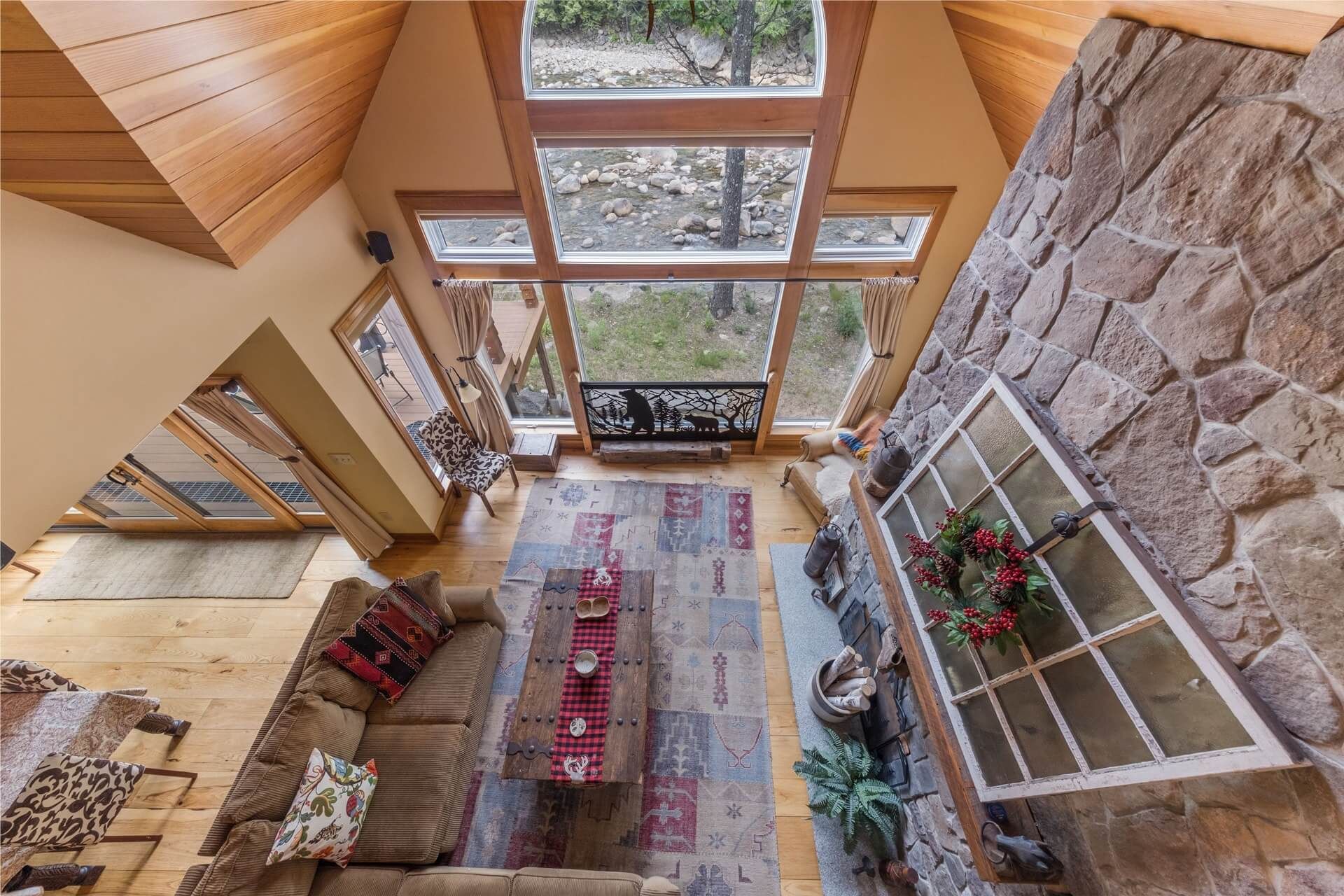 An aerial view of an Airbnb living room with lots of windows cleaned and ready for guests