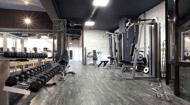 gym cleaning services image of a fitness club after hours where a cleaning crew has steamed the carpets