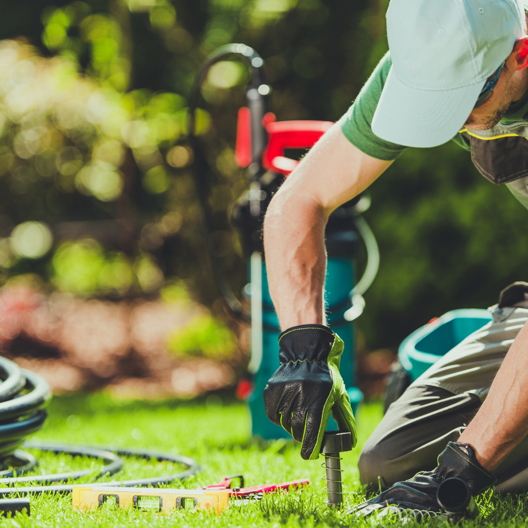 EduLawn Care employee working on an a lawn irrigation System
