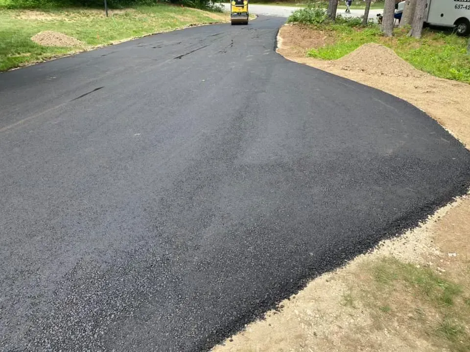 A roller is rolling asphalt on a road.