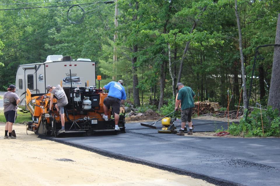 A group of people are working on a road.