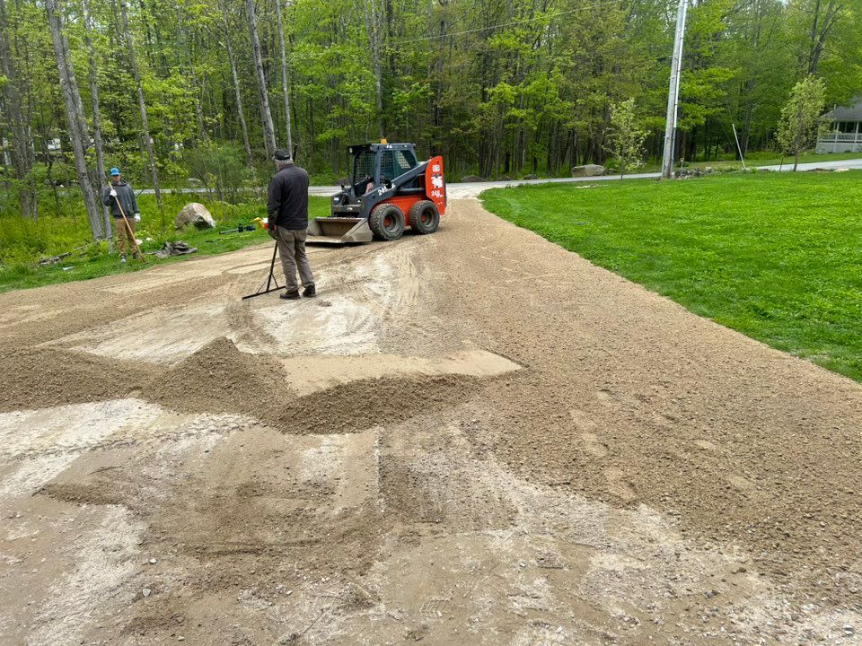 A man is standing next to a bulldozer on a dirt road.