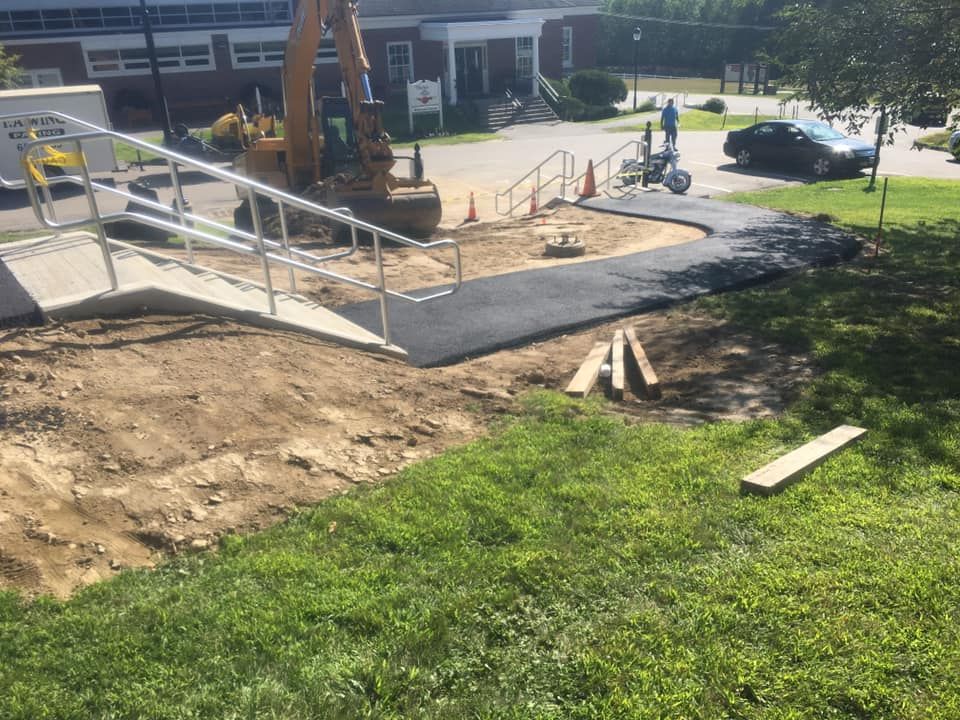 A wheelchair ramp is being built in front of a building
