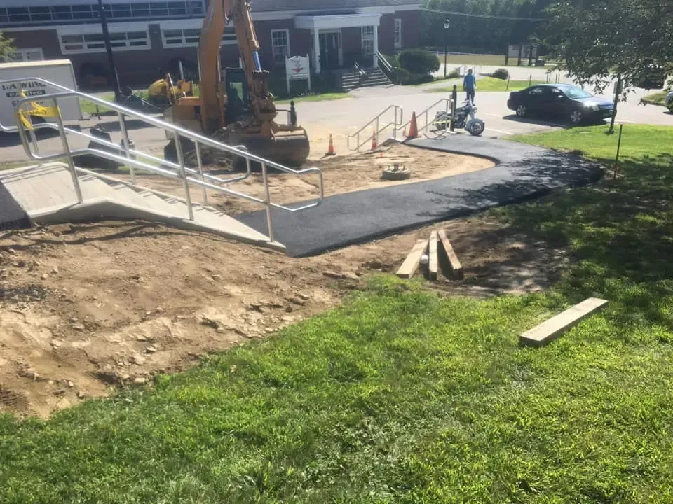 A wheelchair ramp is being built in front of a building.