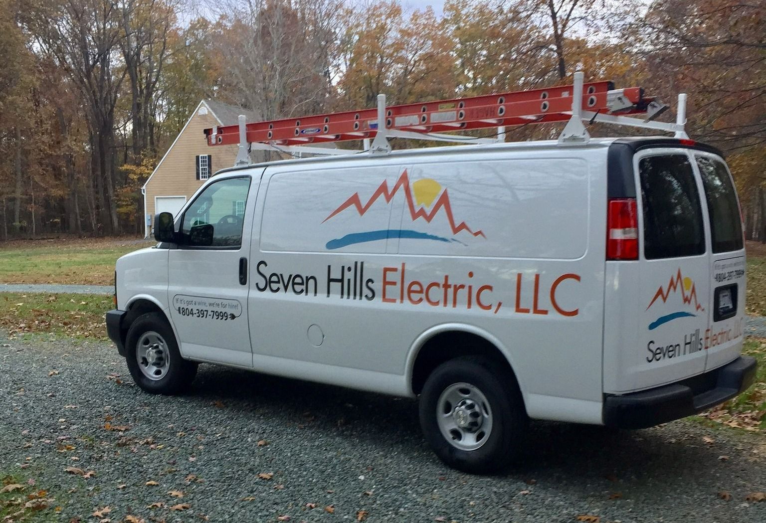 A white van with seven hills electric llc written on the side
